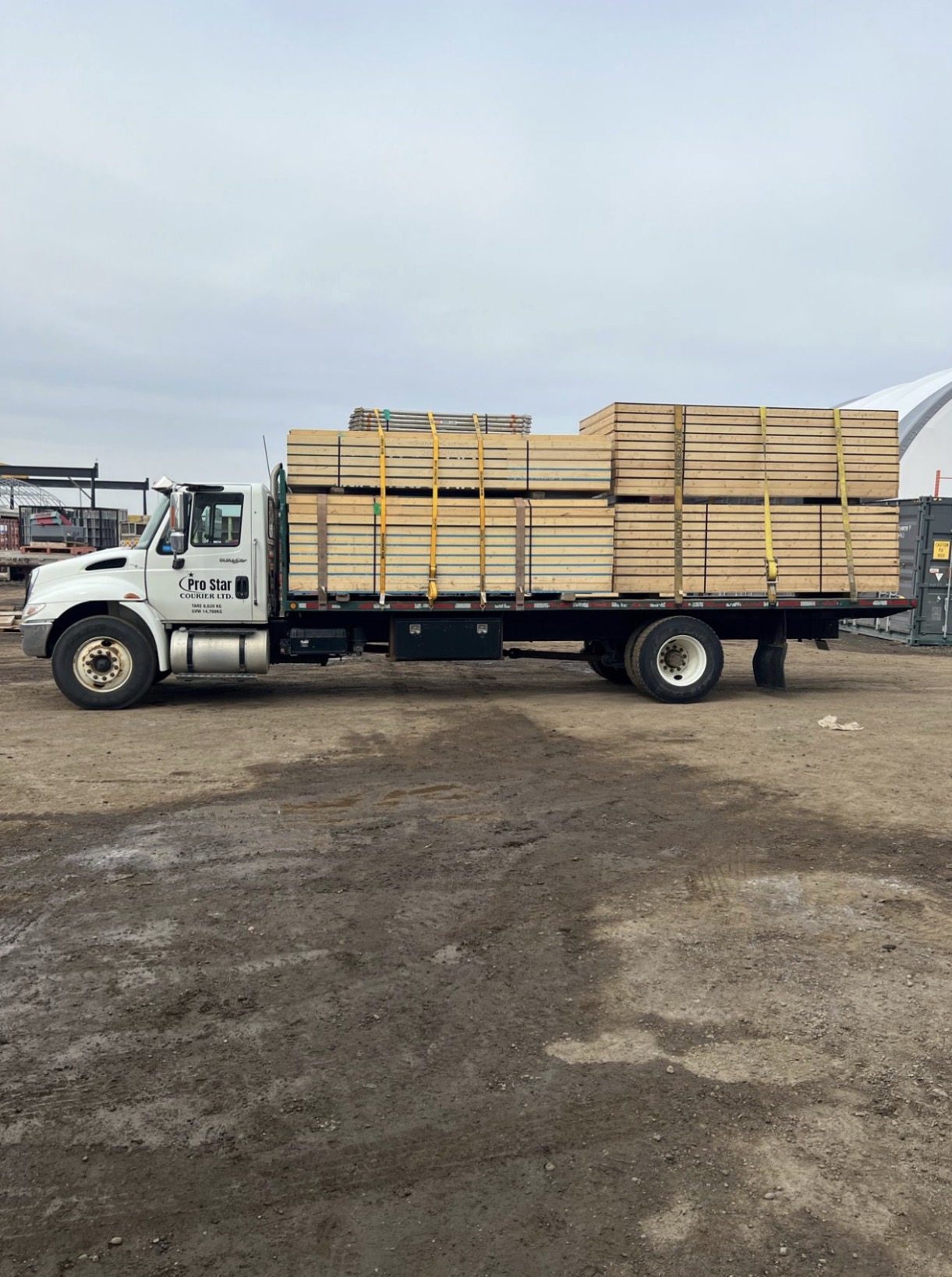 Pro Star Courier truck hauling lumber materials