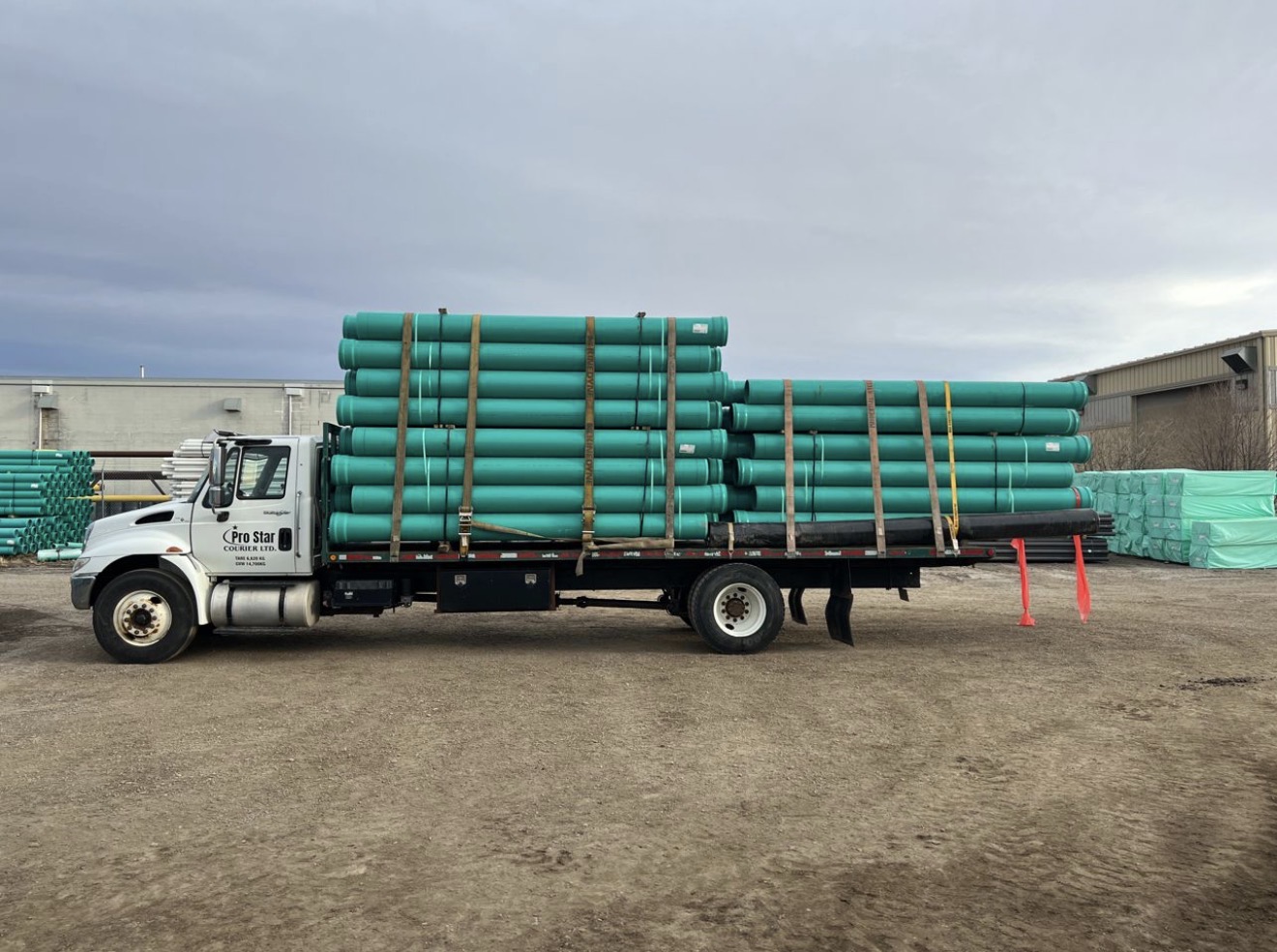 Industrial pipes and materials transport on flatbed