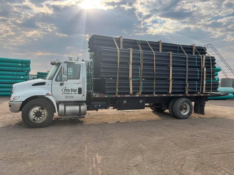 Industrial pipes delivery at sunset with Pro Star Courier truck